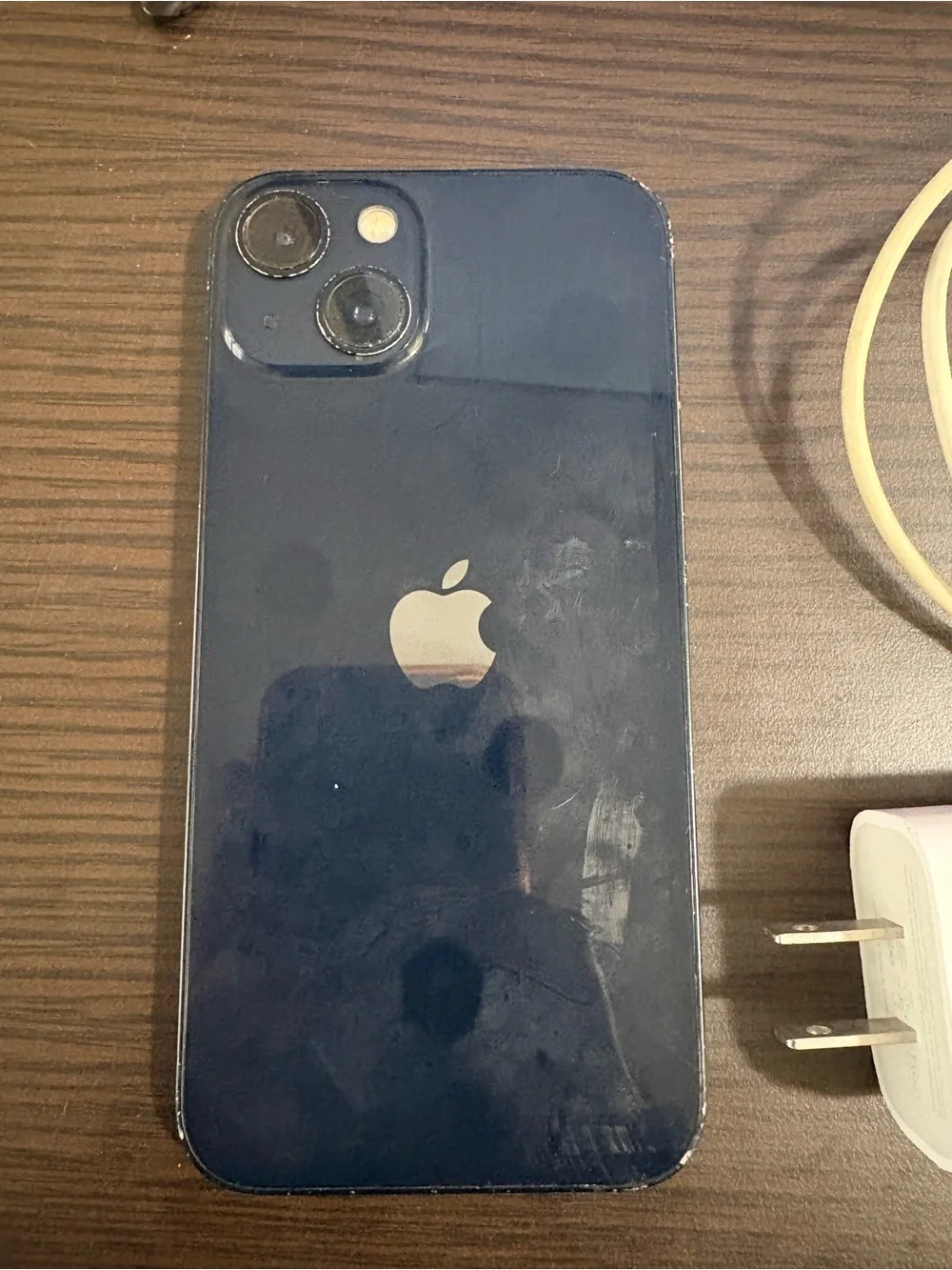 White Smartphone with White Charging Cable and Wall Adapter